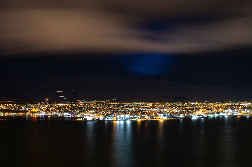City lights reflecting on sea